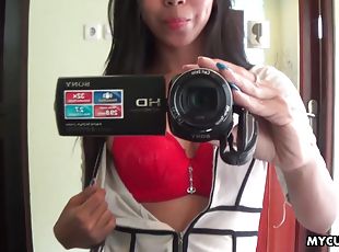 Sexy brunette Asian babe fools around with the camera