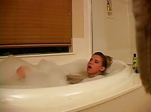 Horny blond is rubbing her cunt in the bathtub