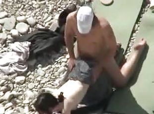 Lewd couple makes love on a nude beach in the presence of their fri...