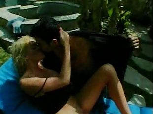 Pretty blonde with big tits sucking cock outdoors
