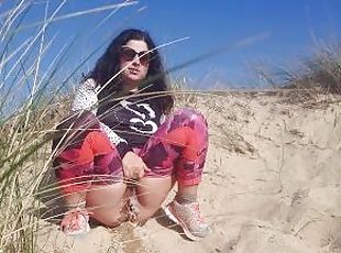 Girl pissing on the beach