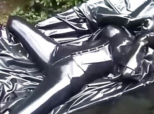 Latex girl full in black rubber and Gasmask chill outs outdoor in g...