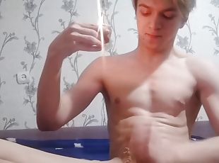 Boy plays with hard dick and candle. Drips on itself with wax