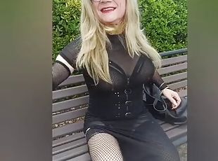 Crossdresser in see-through dress and sexy lingerie outdoors