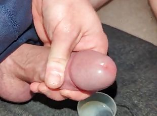 Extreme close up, huge thick load of cum transferred into a cup and...