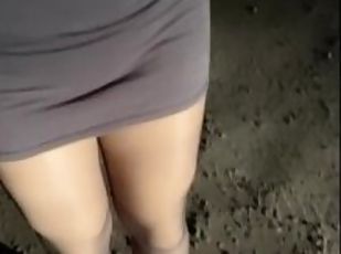 A slut in a short skirt and heels in public