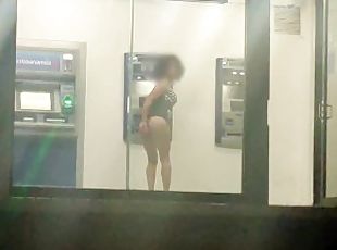 Sissy in slutty dress masturbating her ass in public ATM with dildo...