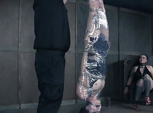 Plastic wrap tight around a bound brunette girl