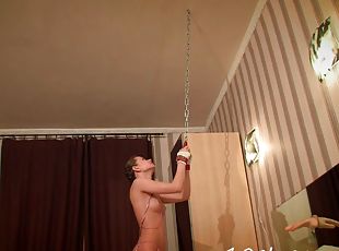 Tying up a slut to the ceiling before having fun with her holes