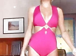 blonde girl in pink swimsuit does catwalk