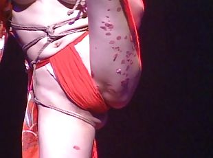 Marvelous Japanese chick in bondage entertains a crowd of people in this live on stage scene