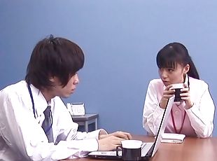 Raven haired Japanese babe delivers a steamy handjob in this office scene