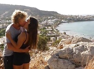 Beautiful teen couple in love passionately kissing above the sea on...