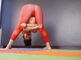 Regina Noir. A woman in yoga leotards practices yoga in the gym. Tr...