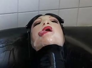 Girl with big boobs encased in black rubber latex catsuit enjoys bucket of hot cumm - part 1