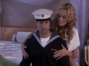 Curly blonde girl rides a dick and gives a handjob to a sailor