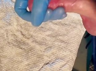 Guy jerks off with latex glove cumshot