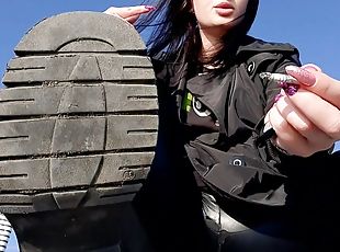 Dirty boot soles for you! Dominatrix Nika is smoking on the beach a...