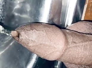 Uncut dick is pissing into the sink for 12th time