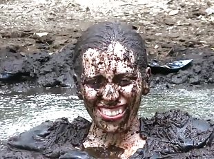 Busty Samantha gets very dirty outdoors in pool of mud