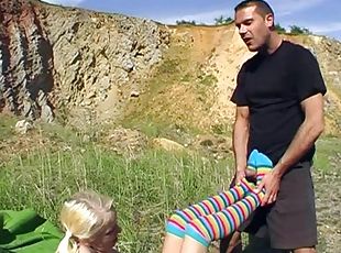Blonde teen gives footjob in socks and gets anal in the nature