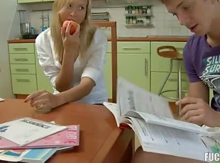 Teen cutie do her homework with her classmate.