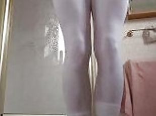 Pissing in skin tight white leggings into a a puddle on the floor w...