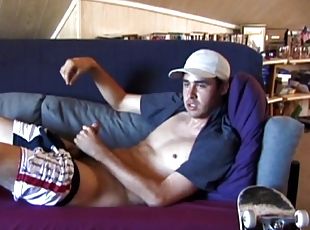 This 21-year-old skater is reclining on the couch and rubbing his b...