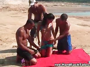 Three guys fuck a bikini girl on a blanket