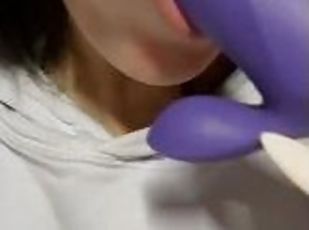 Pretty girl sucking a purple dildo