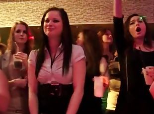 Redhead gives blowjob in a crowded club