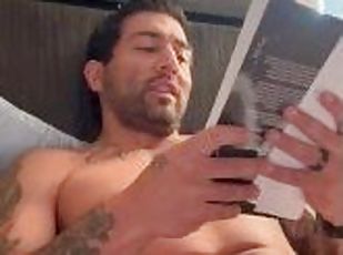 Tattooed sexy man with big enough dick does some naughty reading in...