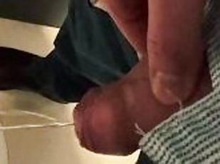 Man unzips his pants pissing in office toilet and shows his wet coc...