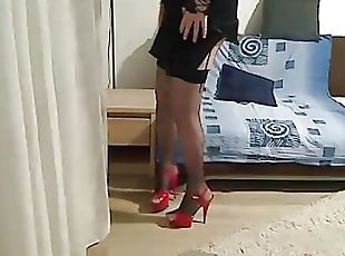 MILF tranny showing off and touching in front of the camera wearing...