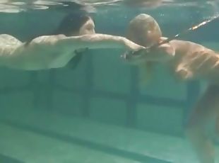 Underwater girls play with a hula hoop