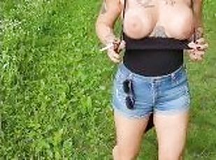 Out in the woods, smoking a cigarette and letting those massive tit...
