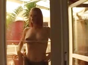 Redhead milks her tits all over the window