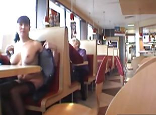 Young brunette flashes her boobs in the restaurant