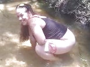 Cute Long Hair Girl pulls down her jeans and panties and pees in popular spring creek