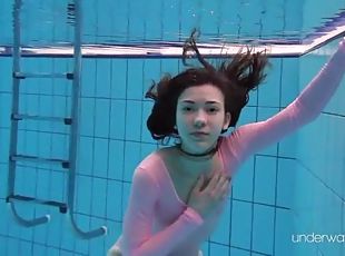 Leggy girl goes swimming in her leotard