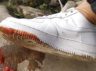 Boy crushes a ketchup packet with his new white sneakers Nike Air F...