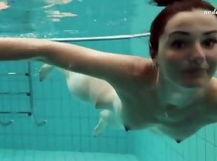 Skinny brunette strips from bikini underwater