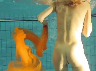 Small tits solo model blonde lovely displays her pussy in pool