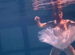 Sensual Russian redhead removes her clothes under the water