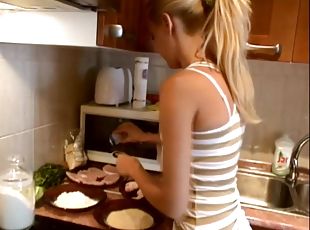 Pretty blonde Sophie Moone cooks breakfast in the kitchen