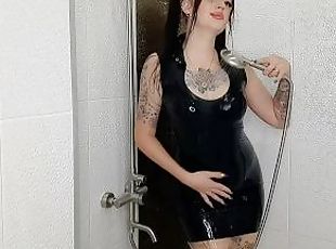 Fetish of latex and rubber. Dominatrix Nika takes a shower in a latex dress.