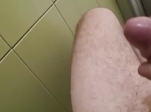 a guy with a big dick jerks off in a public toilet and cums on the ...